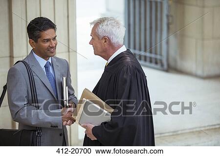 Judge and lawyer talking in courthouse View Large Photo Image Stock Image - Judge and lawyer talking in courthouse. Fotosearch