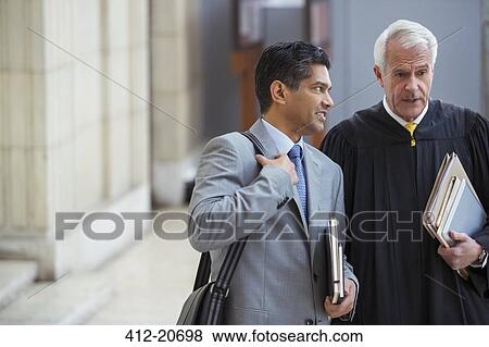 Judge and lawyer talking in courthouse View Large Photo Image Stock Photo - Judge and lawyer talking in courthouse. Fotosearch