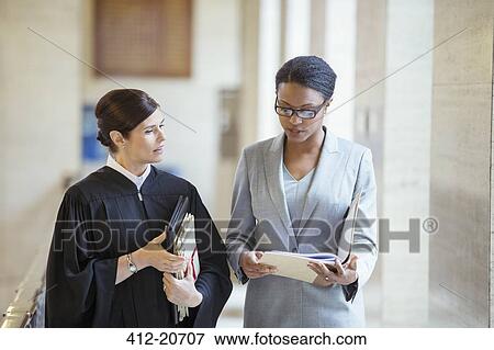 Judge and lawyer talking in courthouse View Large Photo Image Stock Photo - Judge and lawyer talking in courthouse. Fotosearch
