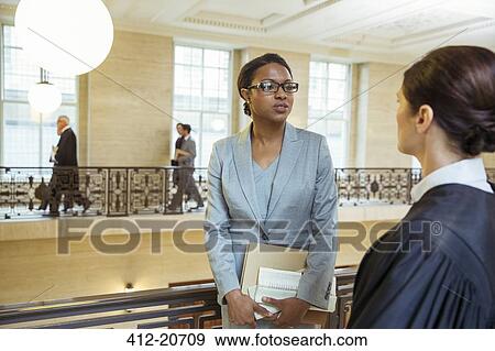 Judge and lawyer talking in courthouse View Large Photo Image Stock Photo - Judge and lawyer talking in courthouse. Fotosearch
