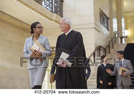 Judge and lawyer walking through courthouse together View Large Photo Image Picture - Judge and lawyer walking through courthouse together. Fotosearch
