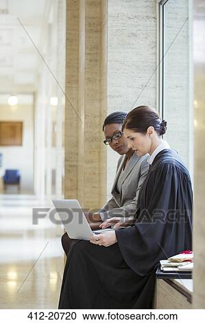 Judge and lawyer working on laptop in courthouse View Large Photo Image Stock Image - Judge and lawyer working on laptop in courthouse. Fotosearch