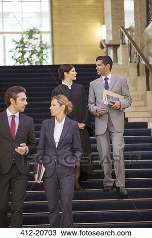Stock Image - Judge and lawyers talking and walking through courthouse. Fotosearch