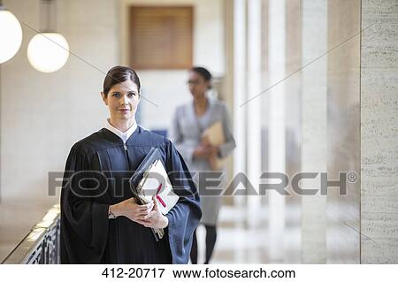 Judge holding legal documents in courthouse View Large Photo Image Stock Photo - Judge holding legal documents in courthouse. Fotosearch
