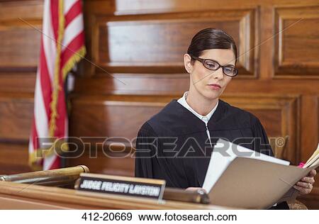 Judge looking through documents and judges bench View Large Photo Image Stock Photo - Judge looking through documents and judges bench . Fotosearch
