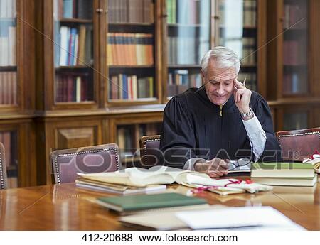 Stock Photo - Judge reading documents in chambers. Fotosearch