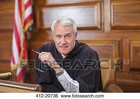 Stock Photograph - Judge sitting at judges bench in court. Fotosearch