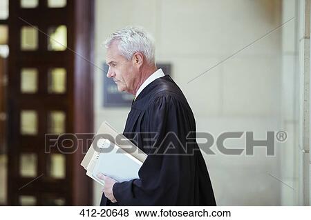 Stock Photo - Judge walking through courthouse. Fotosearch