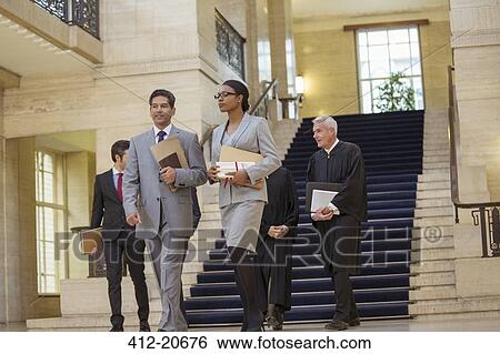 Judges and lawyer walking through courthouse View Large Photo Image Stock Photograph - Judges and lawyer walking through courthouse. Fotosearch