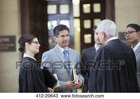 Stock Image - Judges and lawyers talking in courthouse. Fotosearch