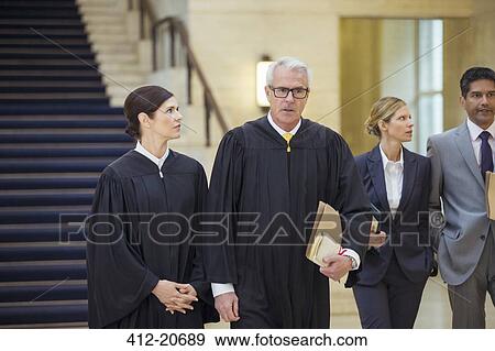 Stock Photo - Judges and lawyers walking through courthouse. Fotosearch