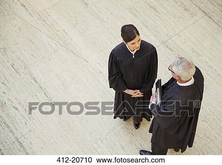 Stock Image - Judges talking in courthouse. Fotosearch