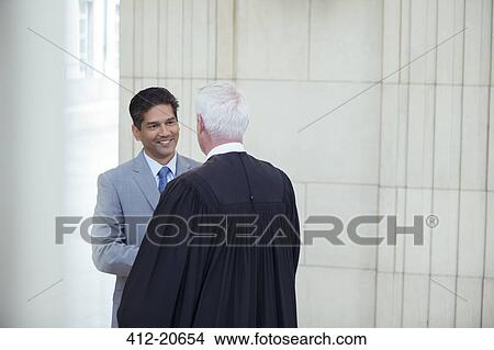 Lawyer and judge talking in courthouse View Large Photo Image Picture - Lawyer and judge talking in courthouse. Fotosearch
