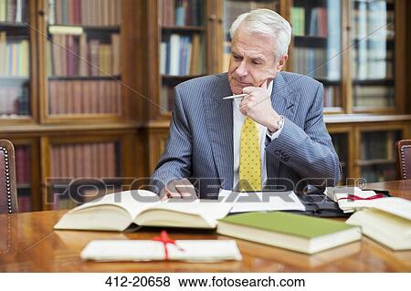 Lawyer doing research in chambers View Large Photo Image Stock Photo - Lawyer doing research in chambers . Fotosearch