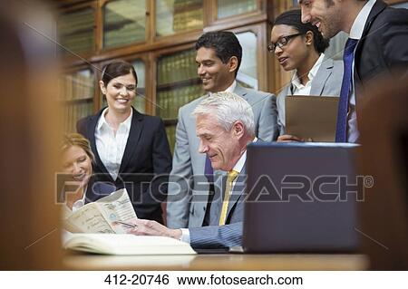 Lawyers examining document together View Large Photo Image Stock Photograph - Lawyers examining document together . Fotosearch