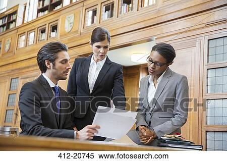Lawyers examining documents in court View Large Photo Image Stock Photography - Lawyers examining documents in court. Fotosearch