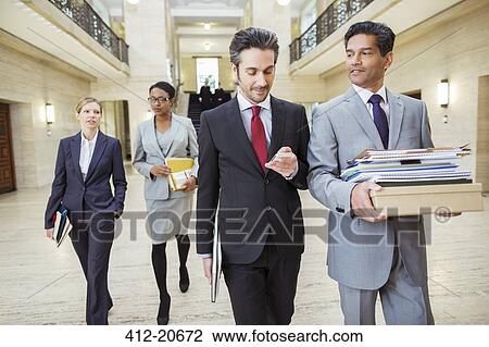 Lawyers walking in courthouse View Large Photo Image Stock Image - Lawyers walking in courthouse. Fotosearch
