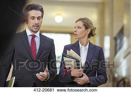 Lawyers walking together through courthouse View Large Photo Image Stock Image - Lawyers walking together through courthouse. Fotosearch