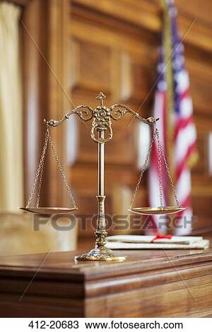 Stock Image - Scales of justice on the judge's bench. Fotosearch