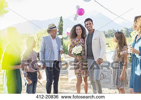 Stock Photograph - Family admiring newlywed couple. Fotosearch