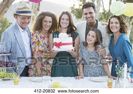 Stock Image - Family celebrating birthday with cake . Fotosearch