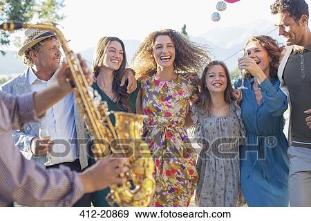 Stock Photo - Family dancing together outdoors. Fotosearch