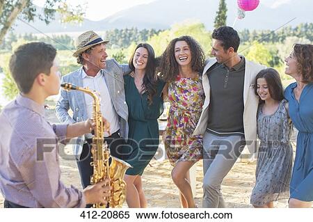Stock Photography - Family dancing together outdoors. Fotosearch