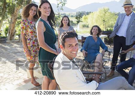 Family gathered on backyard patio View Large Photo Image Stock Image - Family gathered on backyard patio. Fotosearch