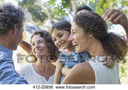 Family hugging outdoors View Large Photo Image Stock Photograph - Family hugging outdoors. Fotosearch