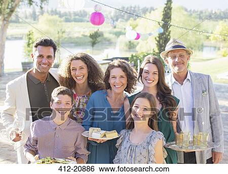 Stock Photograph - Family smiling together outdoors. Fotosearch