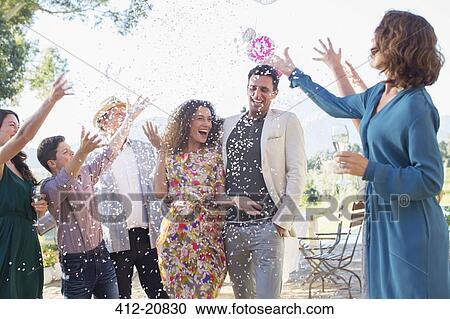 Family throwing confetti on newlywed couple View Large Photo Image Stock Image - Family throwing confetti on newlywed couple. Fotosearch