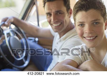 Father and son riding in car together View Large Photo Image Stock Image - Father and son riding in car together. Fotosearch