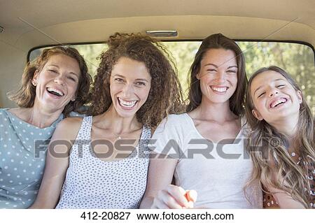 For women sitting in car backseat together View Large Photo Image Stock Photo - For women sitting in car backseat together . Fotosearch