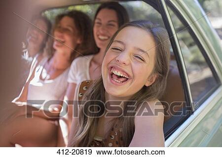 Four women playing in car backseat View Large Photo Image Stock Photo - Four women playing in car backseat . Fotosearch
