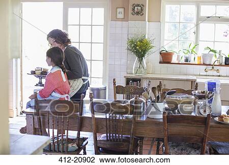 Grandmother offering granddaughter cupcakes View Large Photo Image Stock Image - Grandmother offering granddaughter cupcakes. Fotosearch