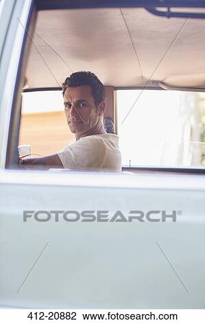 Man driving car on sunny day View Large Photo Image Stock Image - Man driving car on sunny day. Fotosearch