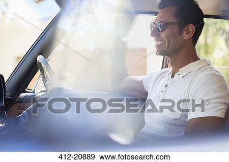 Man driving car on sunny day View Large Photo Image Stock Photo - Man driving car on sunny day . Fotosearch