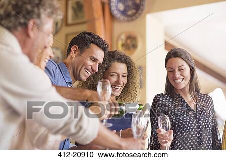 Man pouring drinks to family members View Large Photo Image Stock Image - Man pouring drinks to family members . Fotosearch
