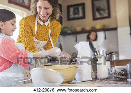 Mother and daughter baking together View Large Photo Image Stock Photograph - Mother and daughter baking together. Fotosearch