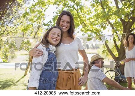 Mother and daughter hugging at family picnic View Large Photo Image Stock Photography - Mother and daughter hugging at family picnic. Fotosearch