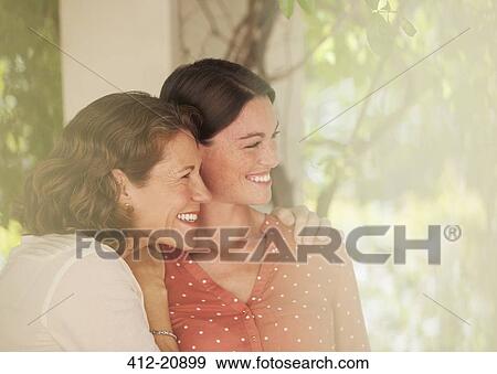 Mother and daughter hugging outdoors View Large Photo Image Stock Photo - Mother and daughter hugging outdoors. Fotosearch