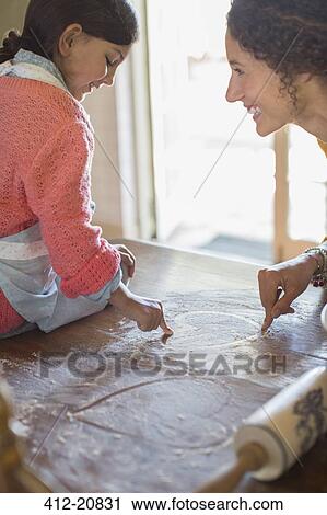 Mother and daughter playing in flower together View Large Photo Image Stock Image - Mother and daughter playing in flower together . Fotosearch