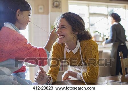 Mother and daughter playing in the kitchen View Large Photo Image Stock Image - Mother and daughter playing in the kitchen . Fotosearch