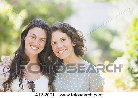 Mother and daughter smiling outdoors View Large Photo Image Stock Image - Mother and daughter smiling outdoors. Fotosearch
