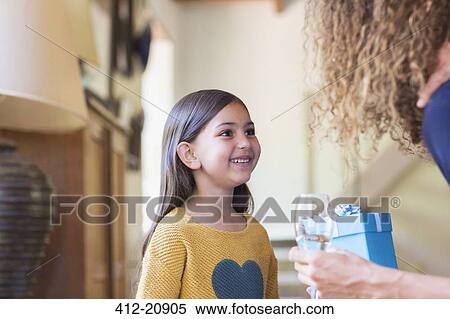 Mother giving daughter gift View Large Photo Image Stock Photography - Mother giving daughter gift . Fotosearch