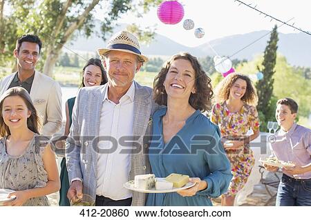Older couple hugging at family picnic View Large Photo Image Stock Image - Older couple hugging at family picnic. Fotosearch