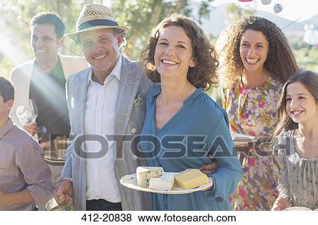 Older couple hugging at family picnic View Large Photo Image Stock Photo - Older couple hugging at family picnic. Fotosearch
