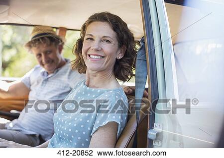 Older couple sitting in front seat of car View Large Photo Image Stock Image - Older couple sitting in front seat of car . Fotosearch
