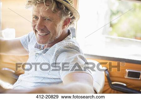 Stock Photo - Older man driving car on sunny day. Fotosearch