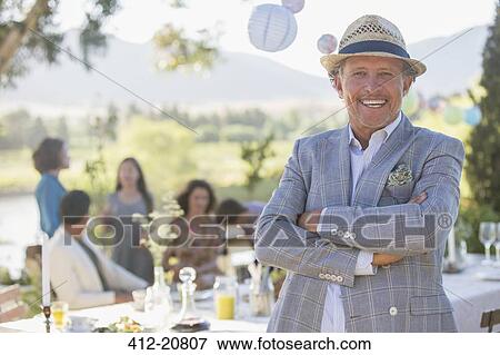 Stock Photo - Older man enjoying picnic with family . Fotosearch